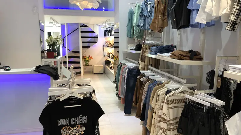Intérieur d’une boutique de prêt-à-porter, portants et étagères